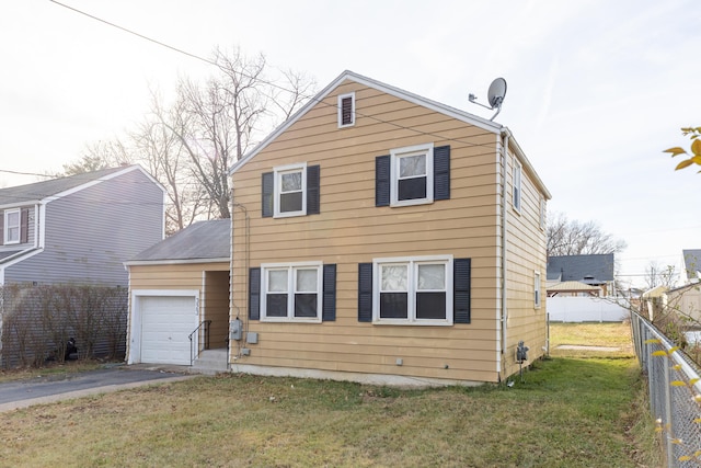 view of front of house featuring a front yard and a garage