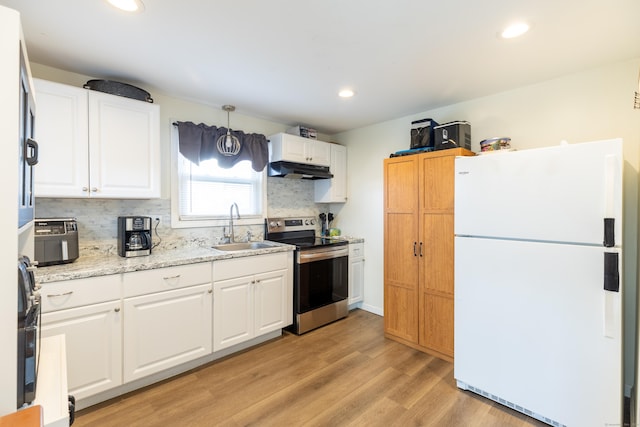 kitchen with electric stove, sink, decorative light fixtures, white fridge, and white cabinetry