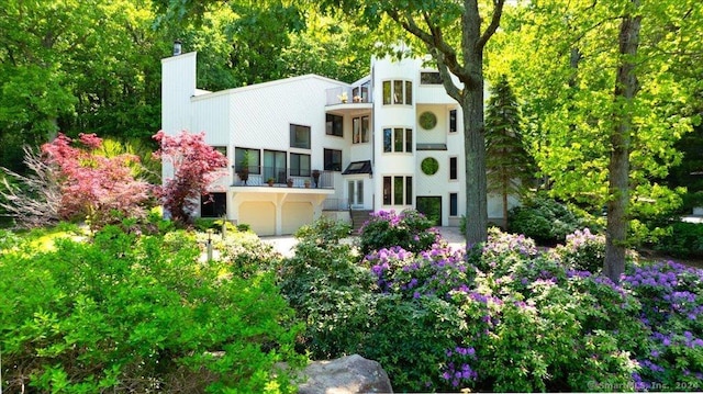 rear view of house with a garage