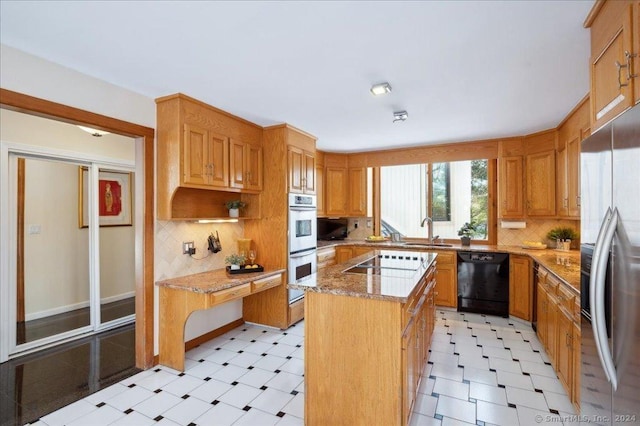 kitchen with a center island, tasteful backsplash, light stone counters, and black appliances