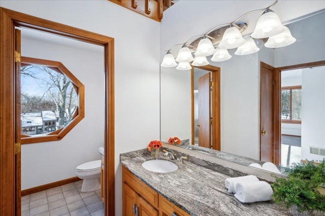 bathroom with tile patterned floors, vanity, and toilet