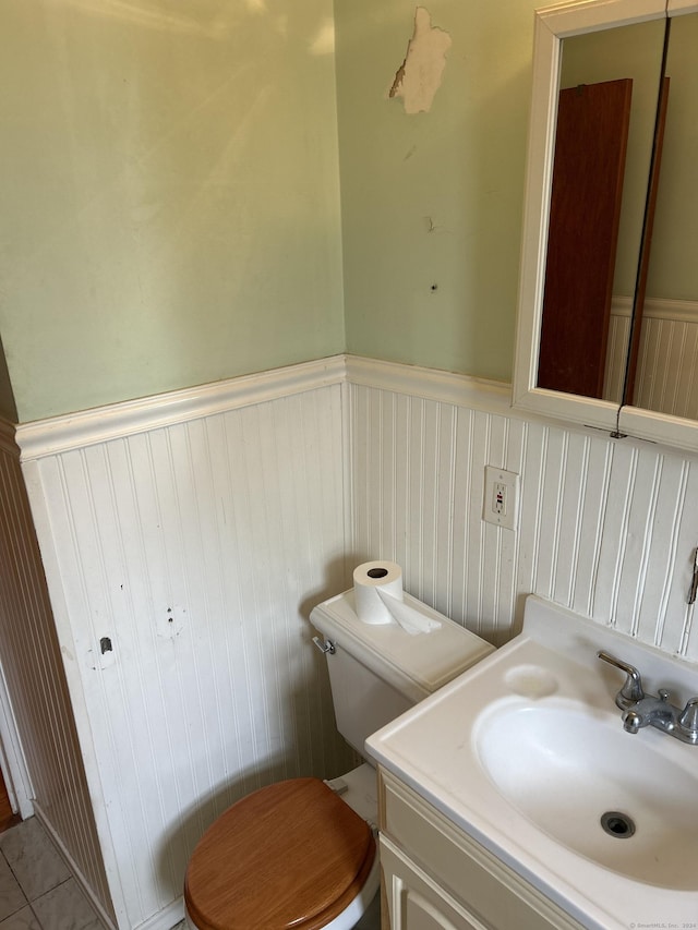 bathroom featuring tile patterned floors, vanity, and toilet