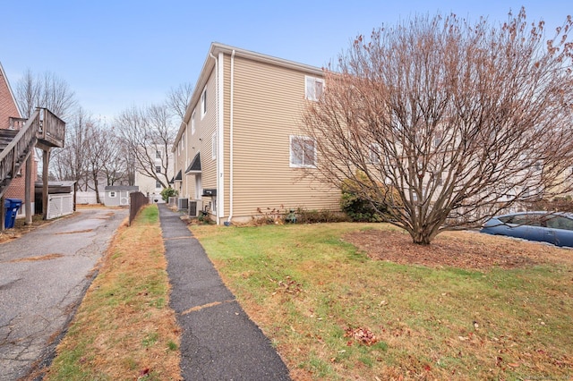 view of home's exterior featuring a yard and central AC unit