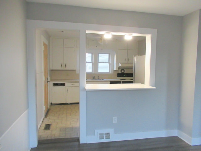 kitchen featuring sink, white cabinets, and white appliances