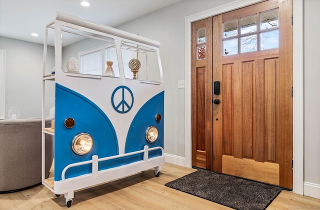 entryway with hardwood / wood-style floors