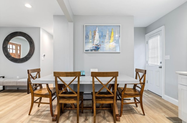 dining space with plenty of natural light and light hardwood / wood-style floors