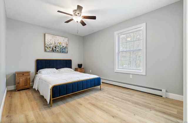 bedroom with ceiling fan, light wood-type flooring, and baseboard heating