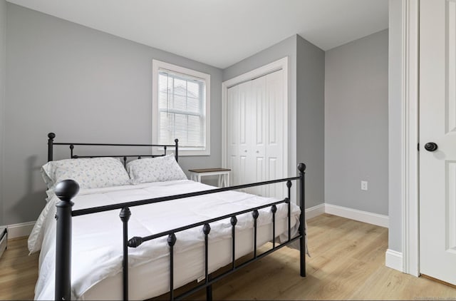 bedroom with light hardwood / wood-style flooring and a closet