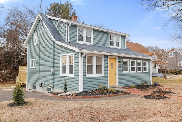 view of front of house featuring central AC unit and a front lawn