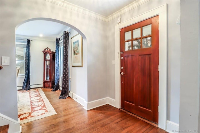 entrance foyer featuring wood-type flooring and crown molding