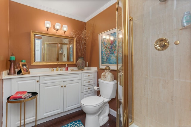 bathroom featuring vanity, a shower with door, crown molding, hardwood / wood-style flooring, and toilet