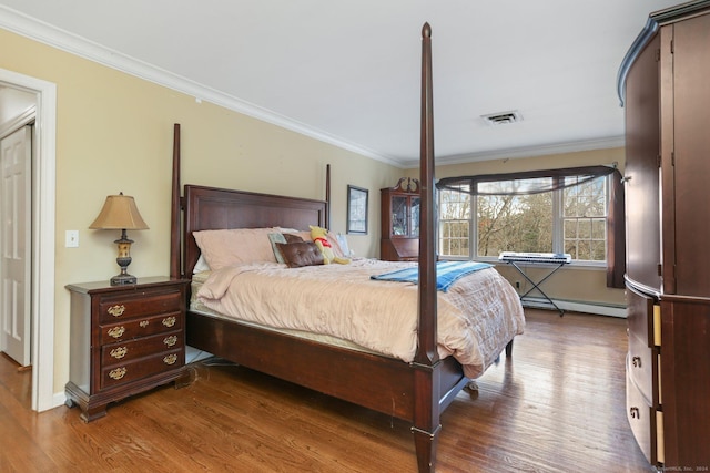 bedroom with ornamental molding, dark wood-type flooring, and a baseboard heating unit