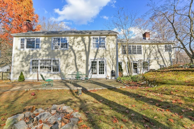 rear view of house featuring a yard and a patio area