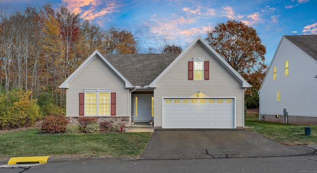 view of front facade with a yard and a garage