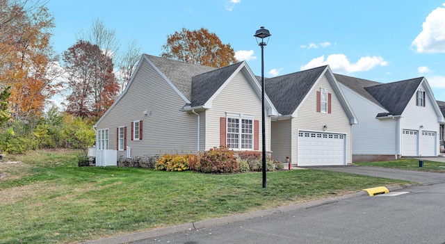 view of front facade featuring a garage and a front lawn