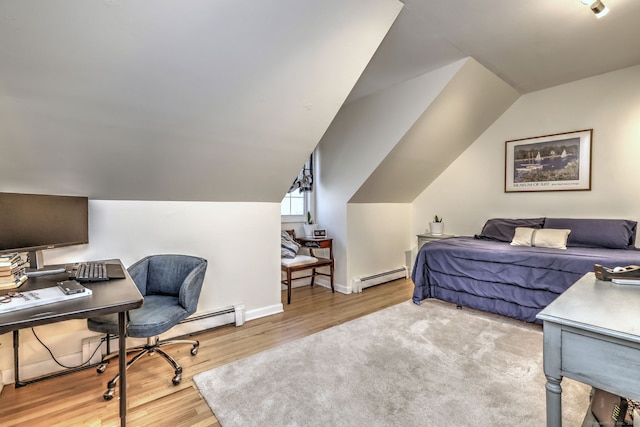 bedroom featuring baseboard heating, light hardwood / wood-style flooring, and lofted ceiling