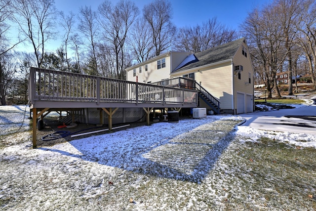 exterior space featuring a garage, a deck, and central AC