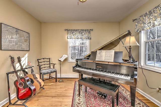 misc room with hardwood / wood-style floors and baseboard heating