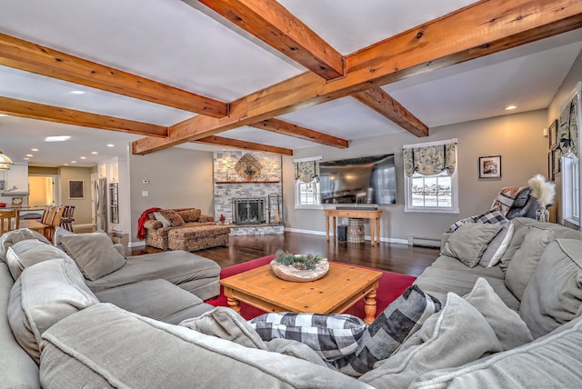 living room featuring a baseboard heating unit, dark hardwood / wood-style floors, beamed ceiling, and a fireplace