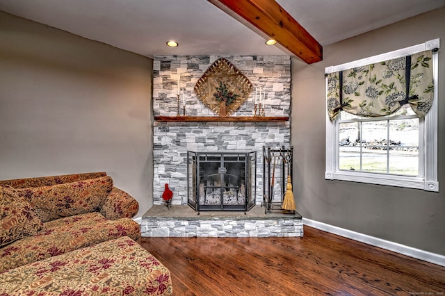 living room featuring hardwood / wood-style floors, beam ceiling, and a fireplace