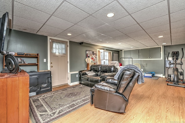 living room featuring a paneled ceiling and wood-type flooring