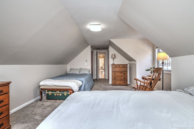 bedroom with vaulted ceiling and carpet flooring