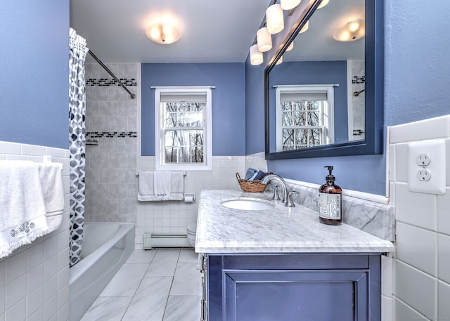 full bathroom with shower / tub combo, tile patterned flooring, a baseboard heating unit, tile walls, and vanity