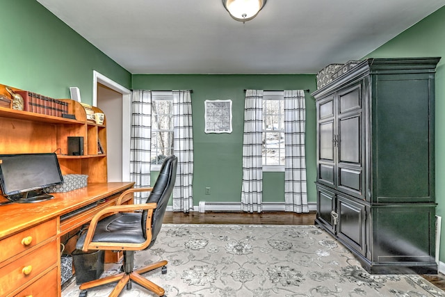 office space with light hardwood / wood-style flooring and a baseboard heating unit