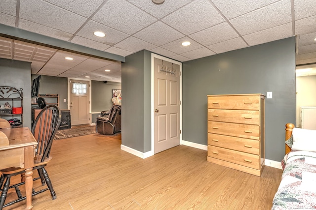 interior space with wood-type flooring and a paneled ceiling