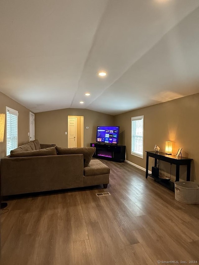 living room with hardwood / wood-style floors and vaulted ceiling