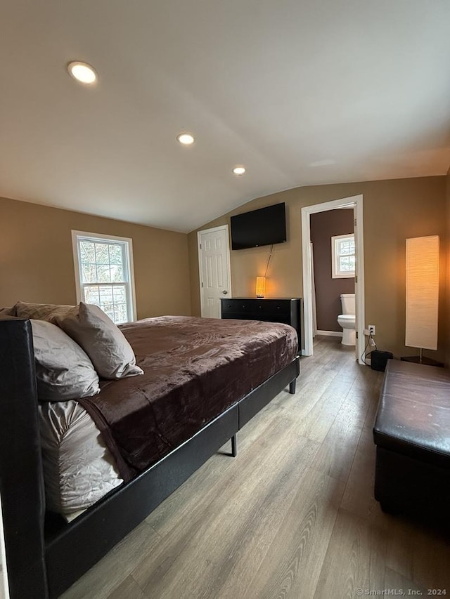 bedroom with ensuite bathroom, wood-type flooring, pool table, and vaulted ceiling