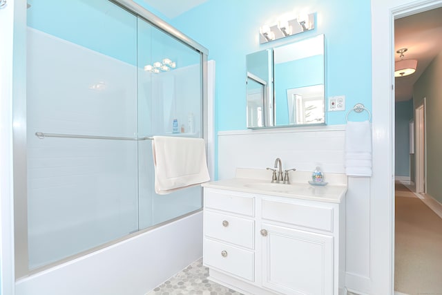 bathroom featuring vanity and enclosed tub / shower combo