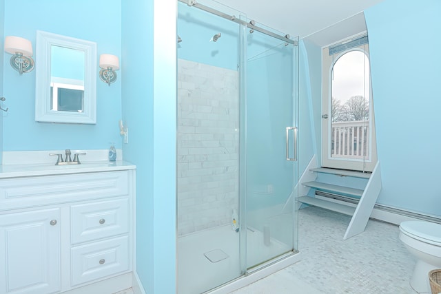 bathroom with vanity, toilet, and a shower with shower door