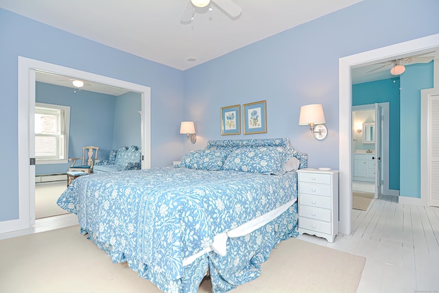 bedroom featuring ceiling fan, connected bathroom, and a baseboard radiator