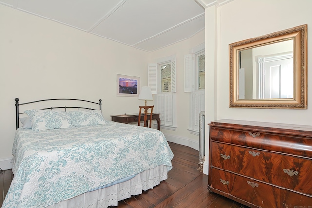 bedroom with dark hardwood / wood-style floors