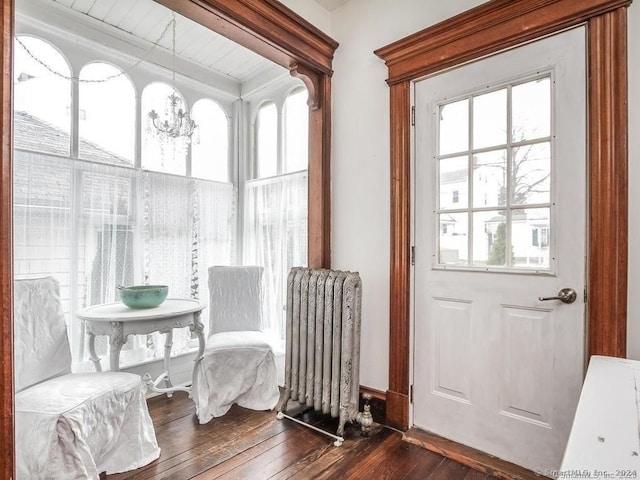 sunroom with a chandelier, radiator heating unit, wooden ceiling, and beam ceiling