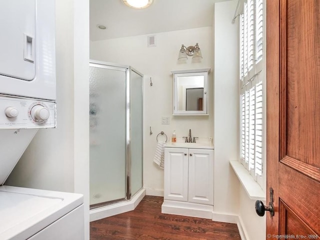 bathroom featuring vanity, wood-type flooring, and a shower with shower door