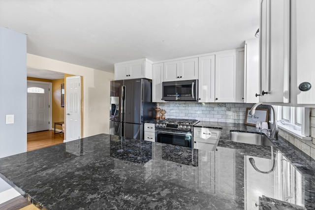 8 Fernwood Ave, Enfield, CT 06082 - kitchen featuring stainless steel appliances, a peninsula, white cabinets, and dark stone counters