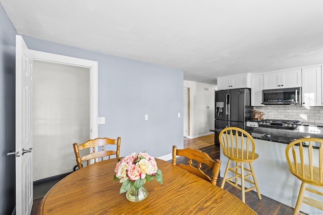 8 Fernwood Ave, Enfield, CT 06082 - dining area featuring dark wood-style floors and baseboards