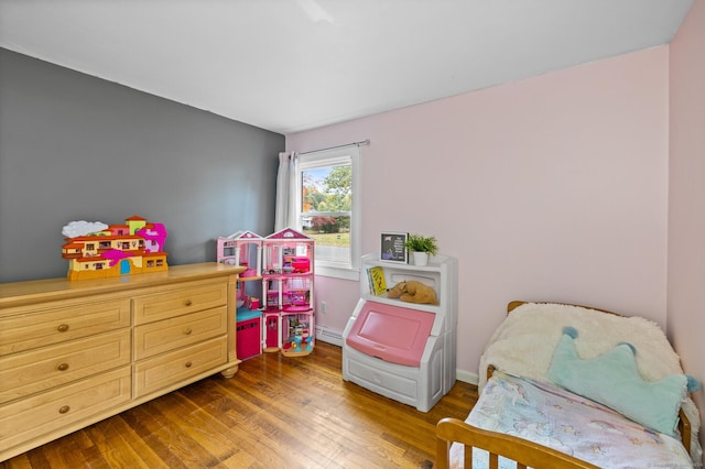 8 Fernwood Ave, Enfield, CT 06082 - bedroom featuring wood finished floors and a baseboard heating unit