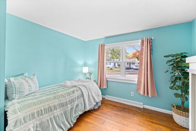 8 Fernwood Ave, Enfield, CT 06082 - bedroom featuring a baseboard heating unit and hardwood / wood-style floors
