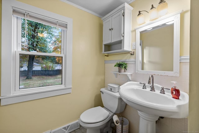 8 Fernwood Ave, Enfield, CT 06082 - half bath featuring crown molding, tile walls, and tasteful backsplash