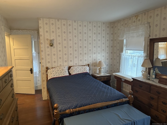 bedroom with dark hardwood / wood-style floors