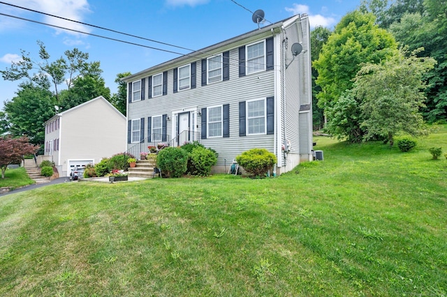 colonial inspired home featuring a front lawn