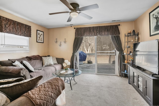 living room with ceiling fan and light colored carpet