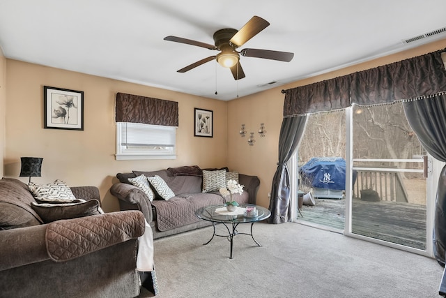 living room with ceiling fan and light colored carpet