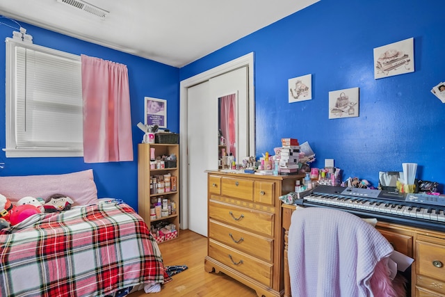 bedroom featuring light hardwood / wood-style flooring and a closet