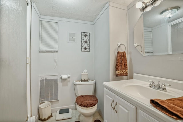 bathroom with tile patterned floors, vanity, toilet, and a textured ceiling