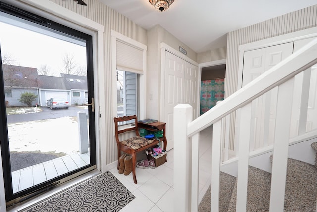 tiled entryway with a healthy amount of sunlight