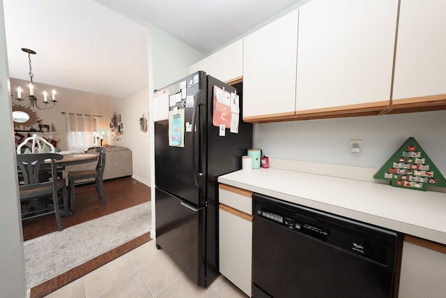 kitchen with white cabinetry, light tile patterned floors, pendant lighting, a chandelier, and black appliances